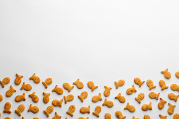 Delicious goldfish crackers on white background, top view