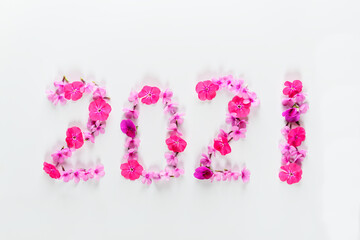 Number 2021 from pink flowers on a white background. New Year concept.