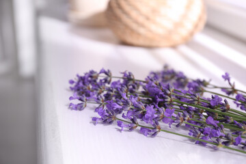 Beautiful lavender flowers on window sill indoors, closeup