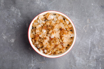 Tasty fried onion on grey table, top view