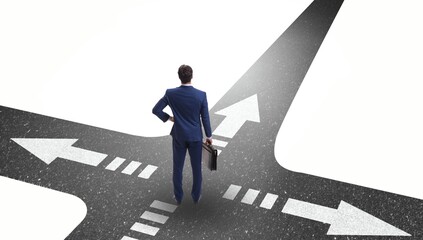 Young businessman at crossroads in uncertainty concept