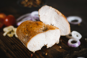 Chicken Breast with onion, tomato on cutting board