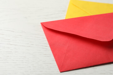 Paper envelopes on white wooden background, closeup