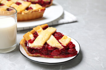 Piece of delicious fresh cherry pie on light grey marble table, closeup