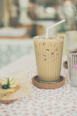 Iced latte coffee in glasses on table served with banana cake