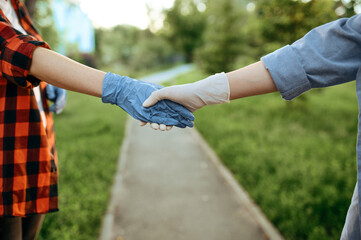 Love couple in gloves walks in park, quarantine