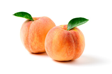 Fototapeta na wymiar Two fresh sweet peach with green leaf isolated on white