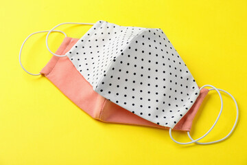 Homemade protective face masks on yellow background