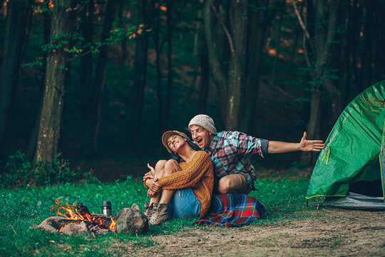 Romantic couple camping outdoors. Happy Man and woman on a romantic camping vacation. Camping photo. Love story. Happy day. Nature background. 