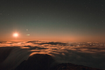 Moonrise, comet and stars landscape above the mountain in autumn season