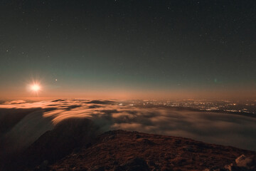 Moonrise, comet and stars landscape above the mountain in autumn season