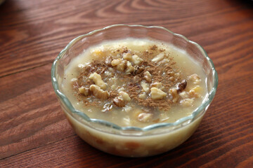 Traditional Turkish dessert Asure with walnuts. (Noah's Pudding). Close up.
