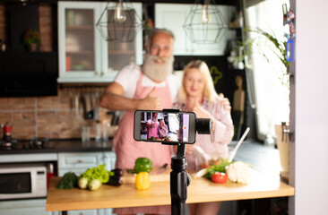 Beautiful couple lover blogger live cooking at kitchen for working from home. COVID-19. Selective focus.