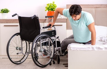 Young handsome disabled man recovering at home
