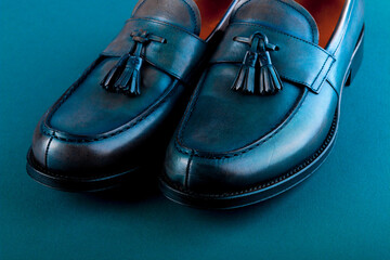 Blue loafer shoes on blue background. One pair. Close up.