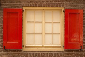 A white and red old window in a street of Amsterdam Holland