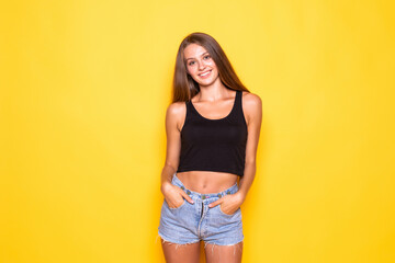 Beautiful young woman in casual wear on yellow background.