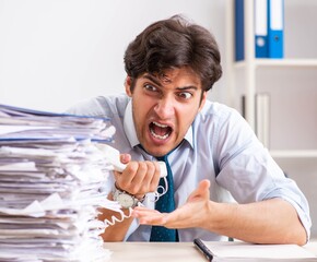 Overloaded busy employee with too much work and paperwork
