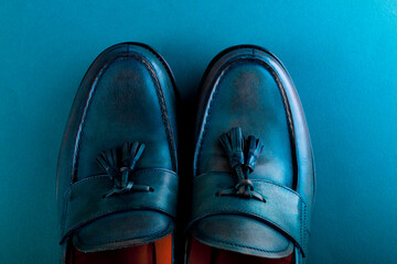 Blue loafer shoes on blue background. One pair. Top view. Copy space.