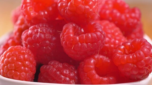 Close up footage of fresh fruits in the kitchen. Beautiful raspberries close up footage.
