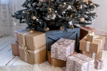 Beautifully decorated Christmas tree with many presents under it.