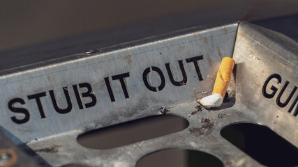 Stub it out - close up of a cigarette stub on a waste bin	
 - obrazy, fototapety, plakaty
