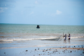 Fishermen using net at sea to fish. João Pessoa, Paraíba, Brazil