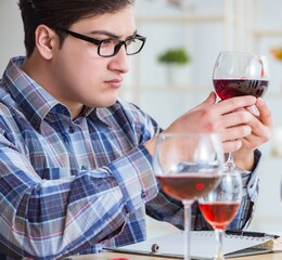 The professional sommelier tasting red wine