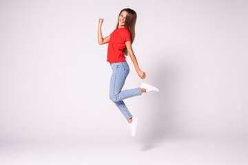 Fototapeta na wymiar Beautiful young jumping girl isolated on white background