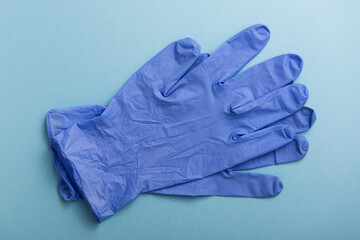 Latex gloves on blue background. Personal Protective Equipment.