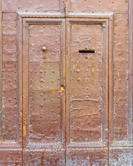 Ornate natural old wooden door frame, brown background