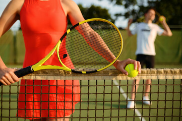 Male and female tennis players with rackets