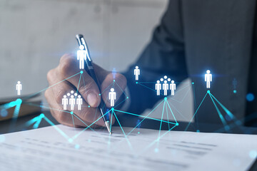 Businessman in suit signs contract. Double exposure with social network hologram. Man signing...