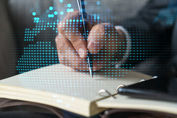 Businessman takes notes background and world map hologram.