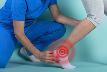 Obraz premium Girl performs exercises with a physiotherapist. Cyan background