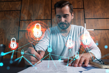 Handsome man working on Data protection project. Multiexposure. Lock icon hologram.