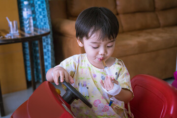 Little Asian boy is taking medicine with syringe in the patient room in hospital.  Healthcare medical and people concept.