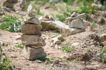 Folded pyramid of different stones in the mountains.