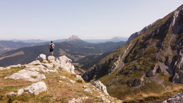 man  on a mountain summit taking a picture. Urkiola, basque country, spain