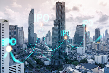IPO icon hologram over panorama city view of Bangkok, the hub of initial public offering in Asia. The concept of exceeding business opportunities. Double exposure.