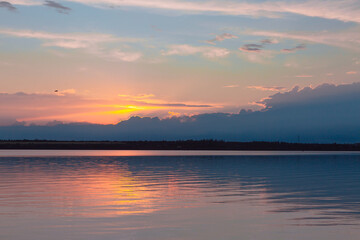 colored sunset over the river, with sky reflection