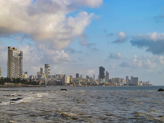 Mumbai skyline near Ocean with dramatic blue sky and clouds, India 