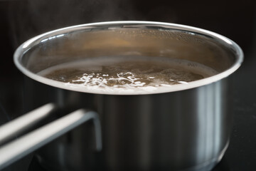 Cooking fusilli in boiling water closeup