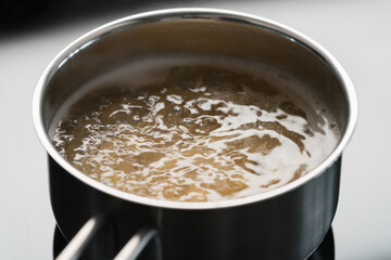 Cooking fusilli in boiling water closeup