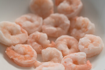 Frozen pre cooked shrimps in white bowl