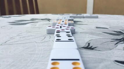 Young girl and boy playing domino game in the garden. - Powered by Adobe