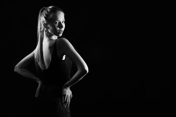 Girl on a black background in fashionable clothes