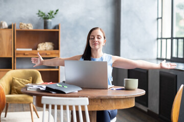 Caucasian business woman stretches her body after hard worling day.
