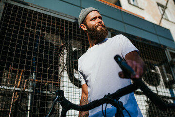 Young bearded hipster guy wearing white blank t-shirt. Mock-up for print. T-shirt template.