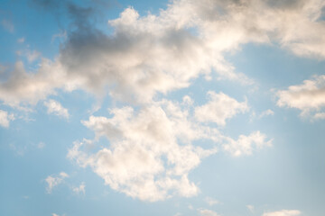 Blue sky with floating white clouds. The background.